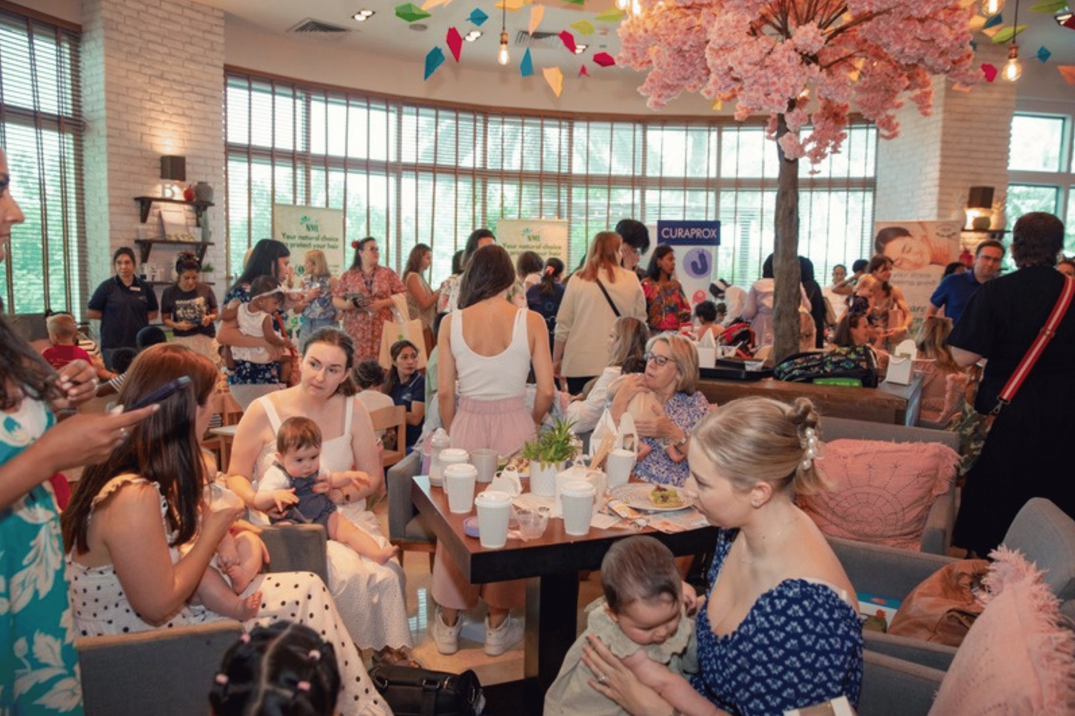 A busy café full of mums and babies at a Happy Families event