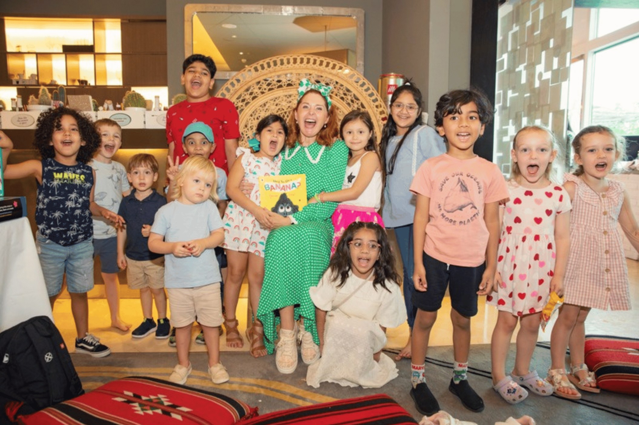 Happy children cheering with Principal Lisa after storytime