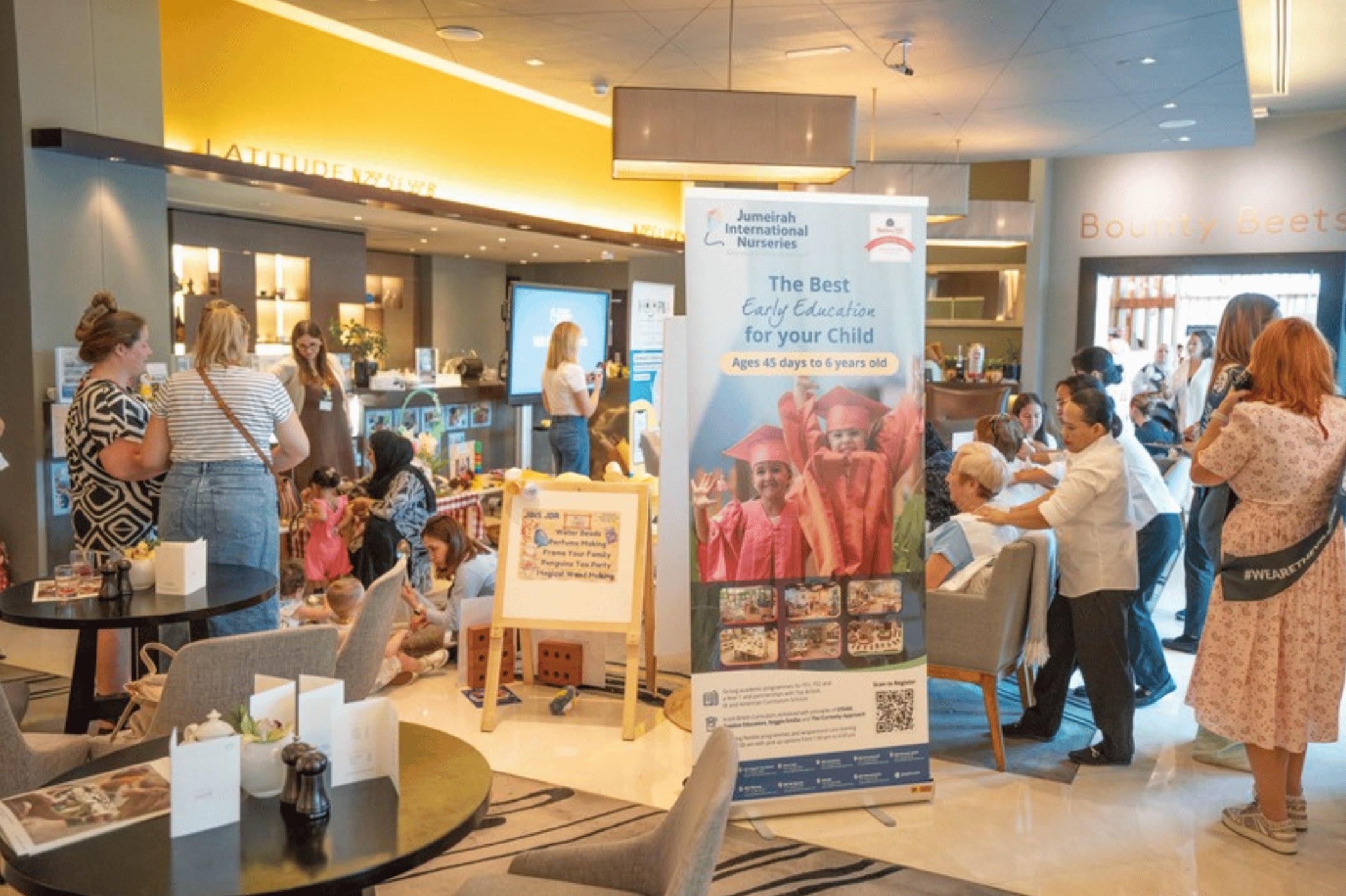 Families browsing a brand's stand at a Happy Families festival