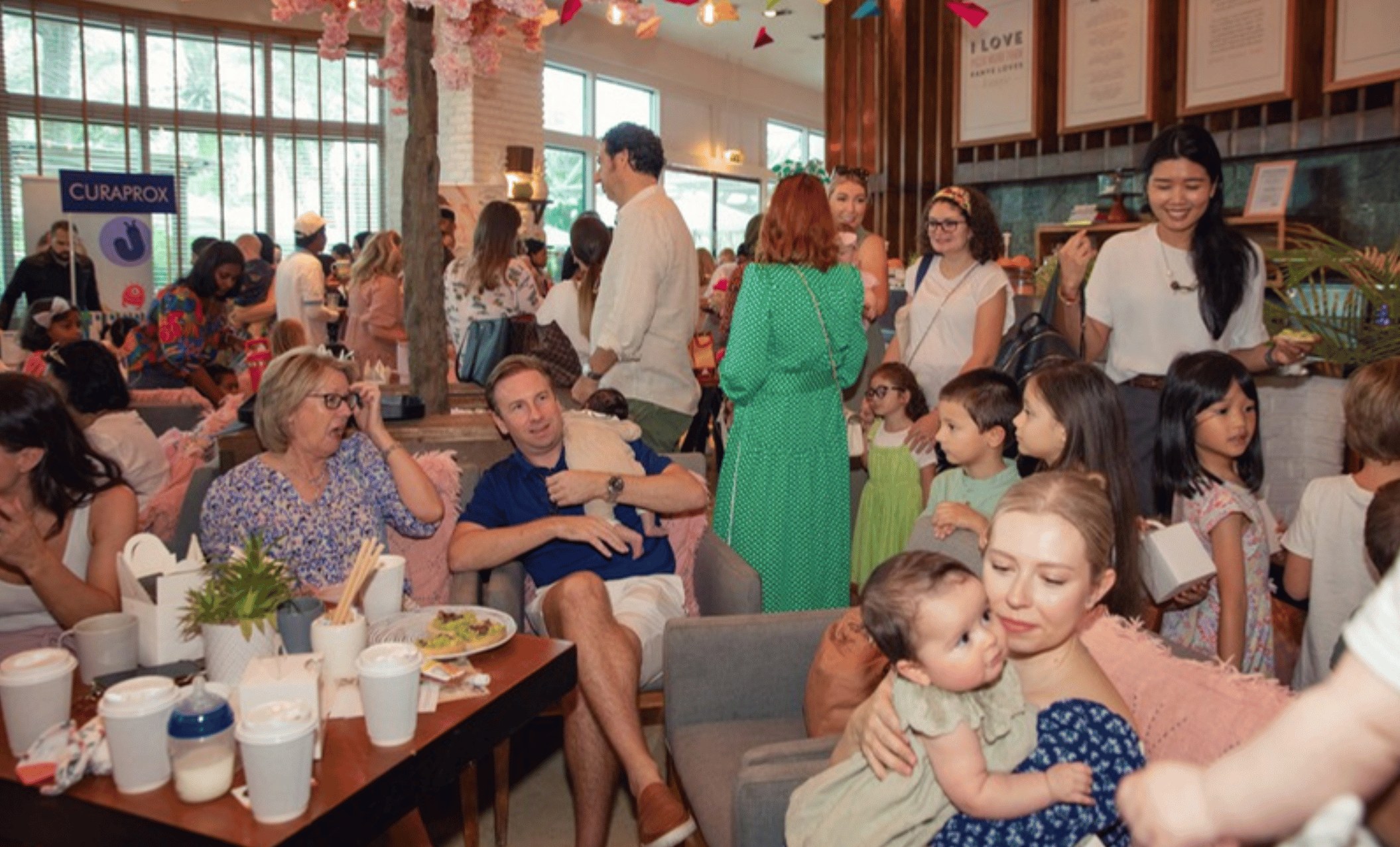Families mingling and chatting at a Happy Families event