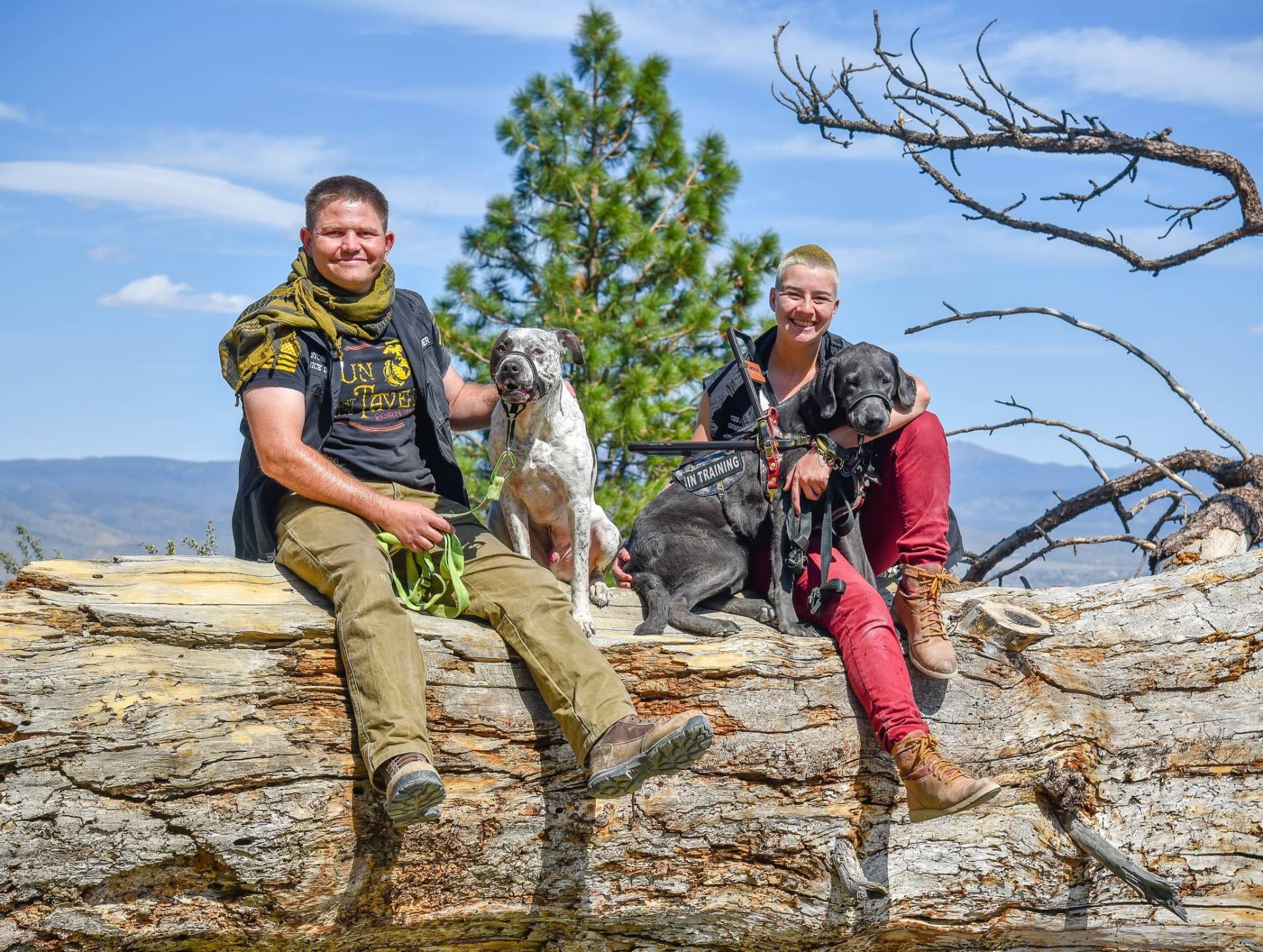 Kendall and Chan with their dogs on a mountain trail