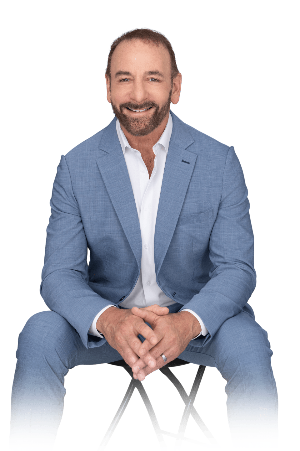 Dr. Stephen Petteruti in a suit, sitting and smiling