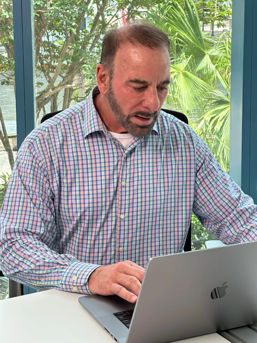 Dr. Stephen Petteruti working on a laptop.