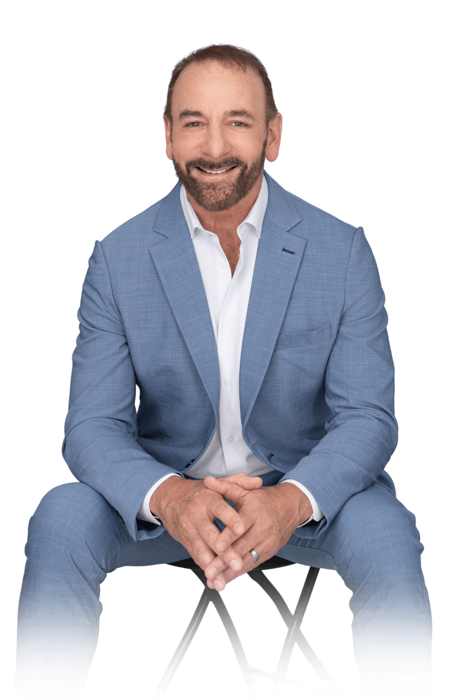 Dr. Stephen Petteruti in a suit, sitting and smiling
