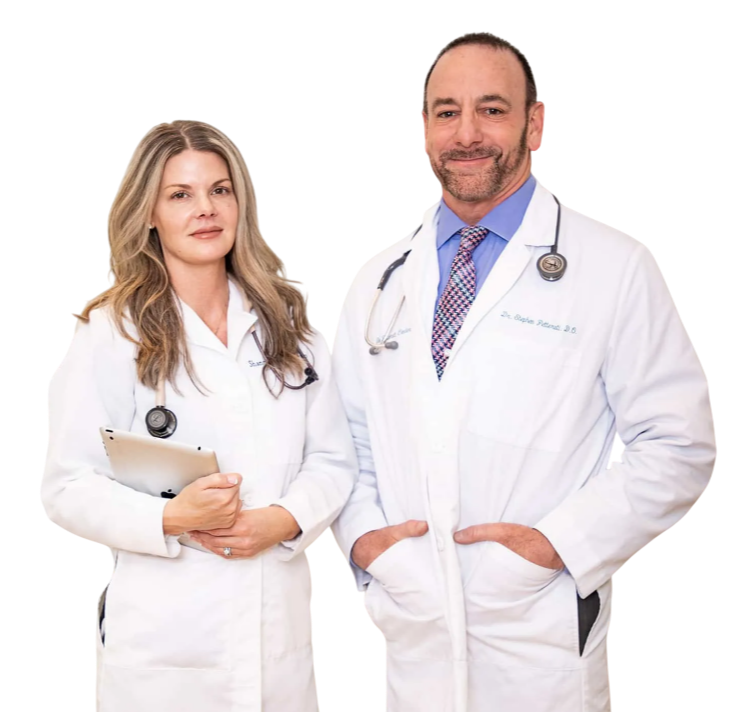 Dr. Stephen Petteruti and Shannon standing with white coats on ready for a consultation