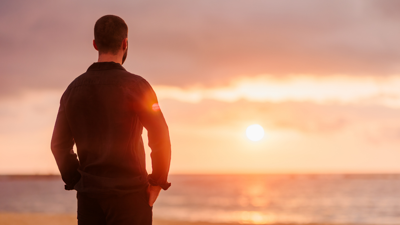 Man at sunset representing prostate health, prostate biopsy decisions, and thoughtful prostate cancer care