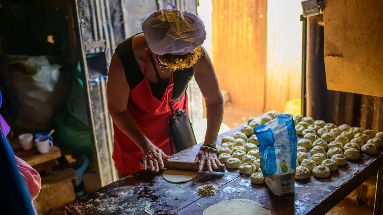 Renee rolling chapati in Kenya, reflecting on food, women's wisdom, and the knowledge carried through generations and across continents.