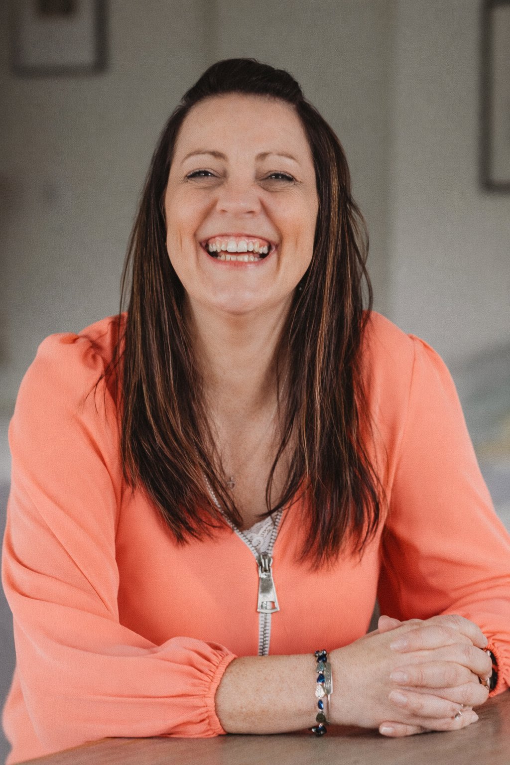 Rachel Flower, founder of PowerVox, smiling and leaning on a table