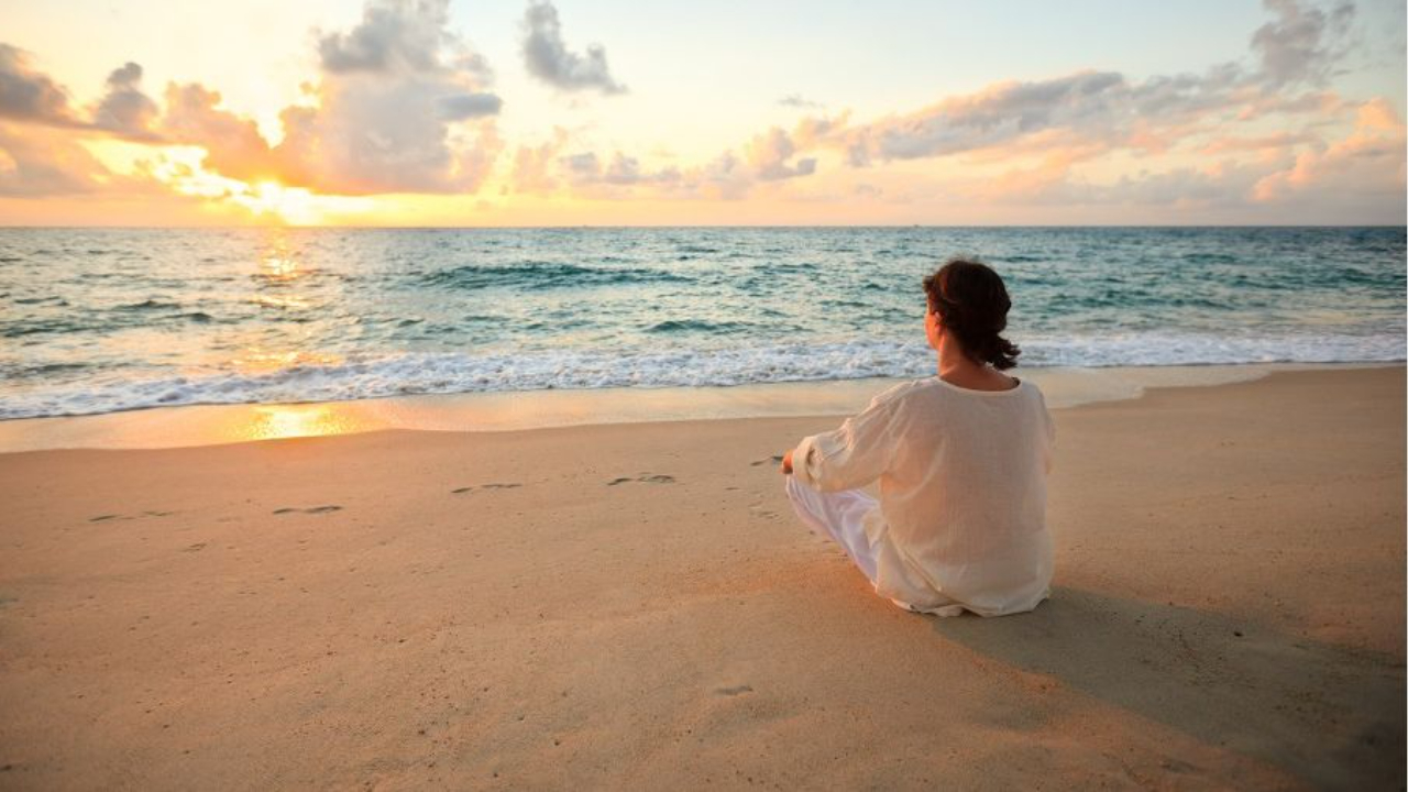 Woman alone on a quiet beach, representing rebuilding self-trust in midlife and beginning again after years of putting yourself last.