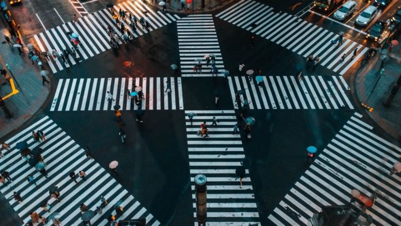 Aerial view of a busy city crossing, representing choices, hesitation, and the feeling of starting and stopping in midlife.