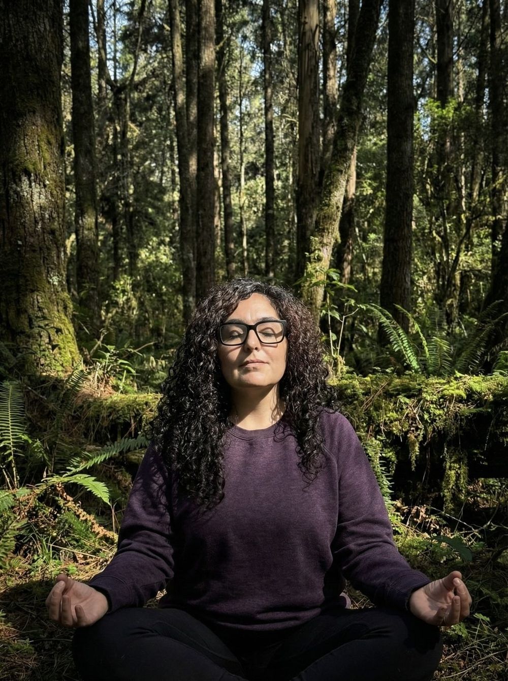 Erika Venegas meditando con los ojos cerrados en el bosque