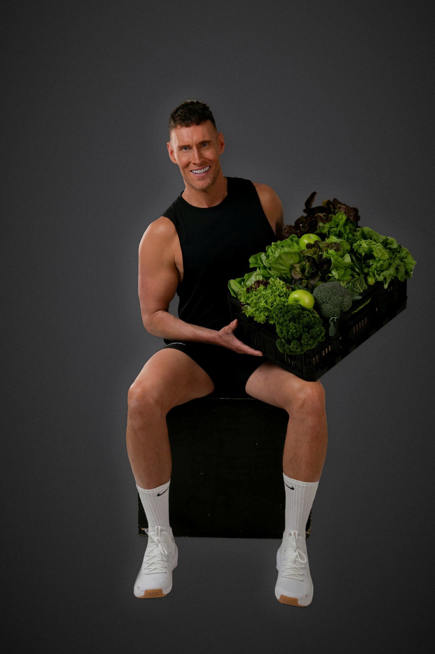 Luke Hines holding a crate of fresh greens