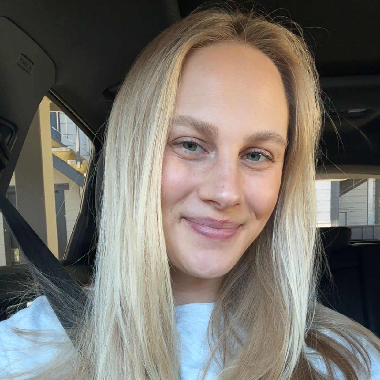 a woman is buckled in a car