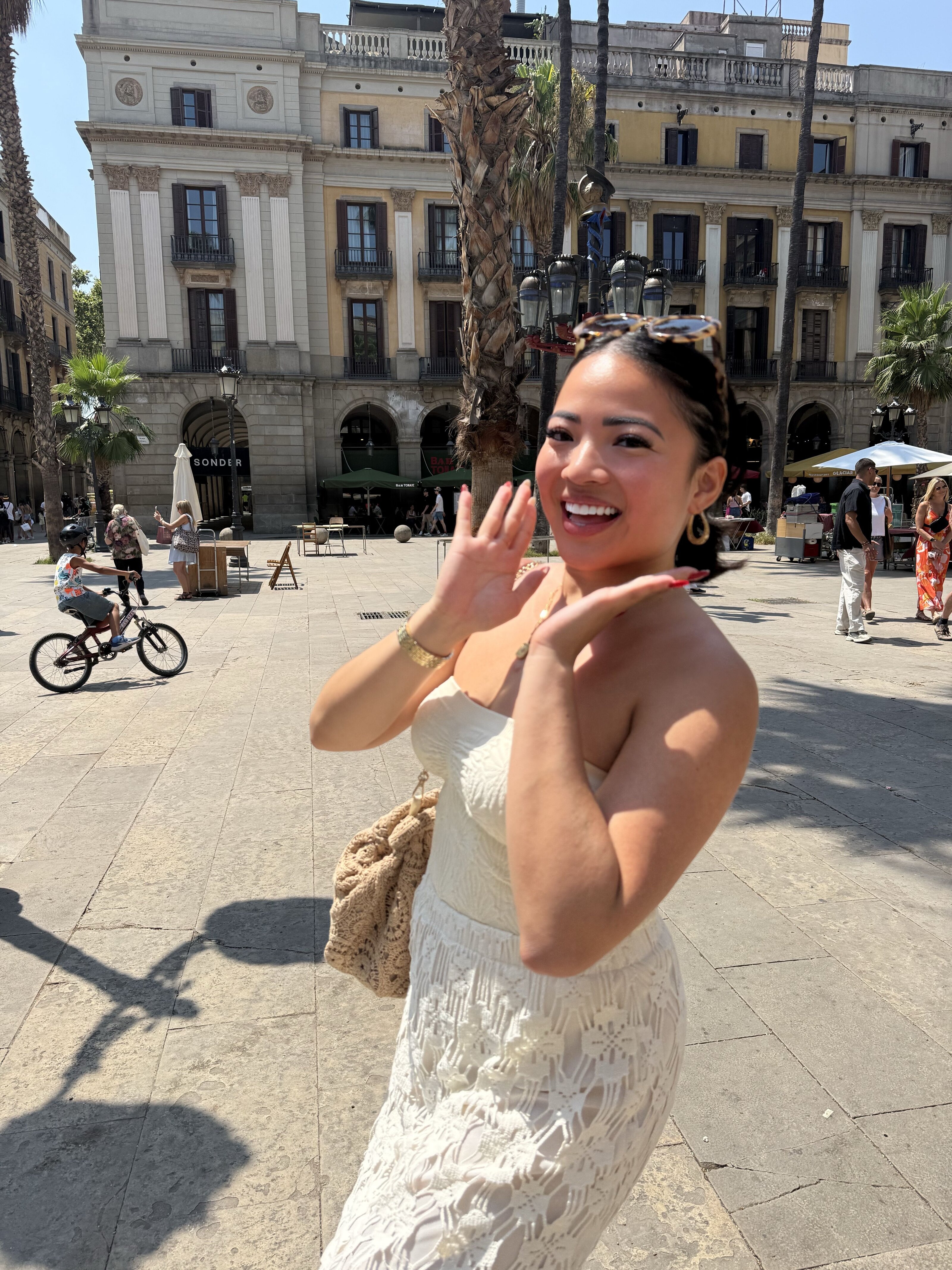 Megan smiling in a sunny city square