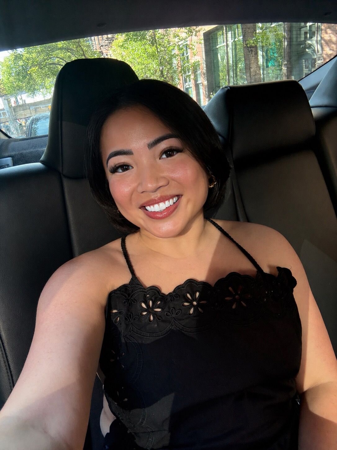 Megan smiling in a car selfie
