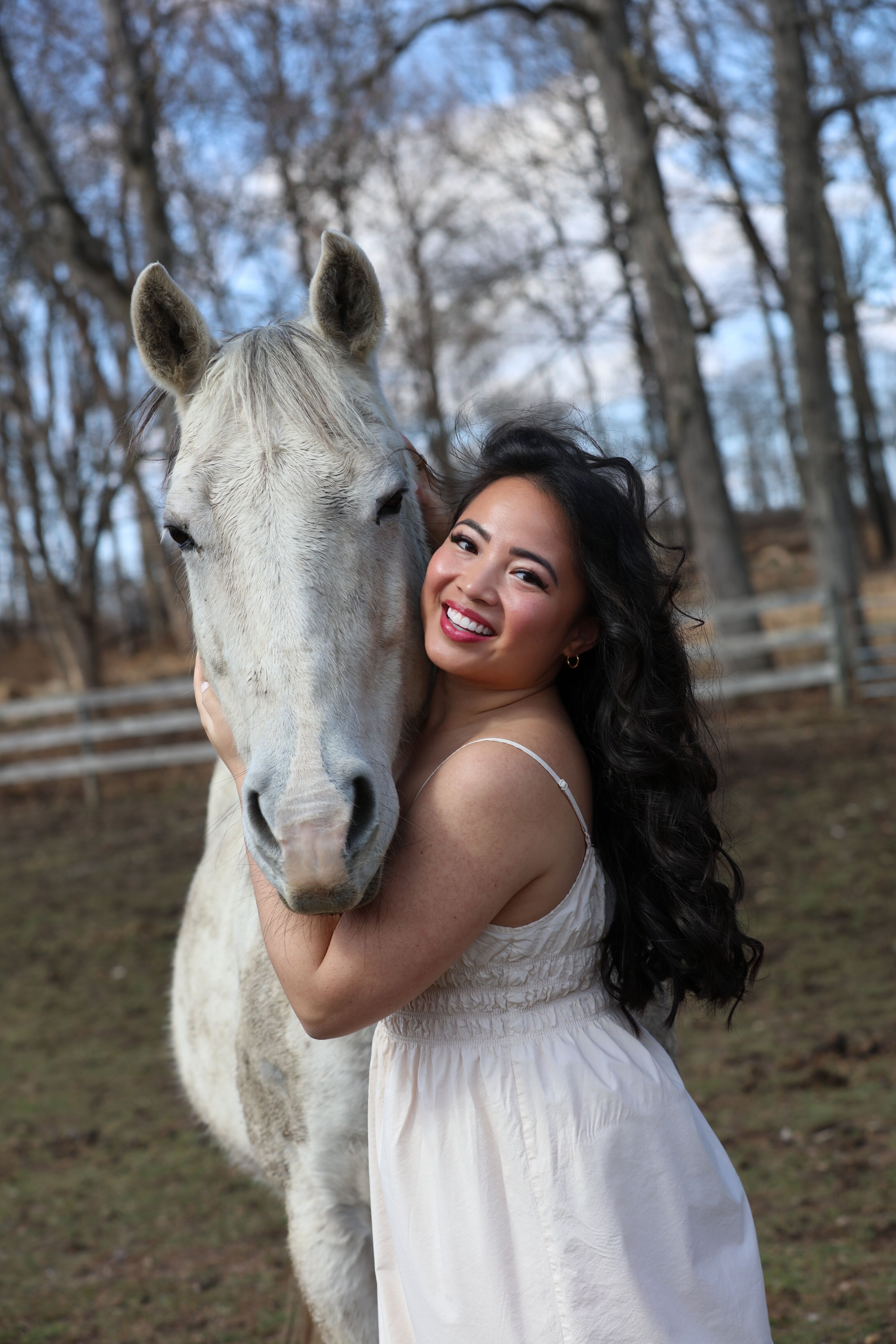 Megan hugging a white horse