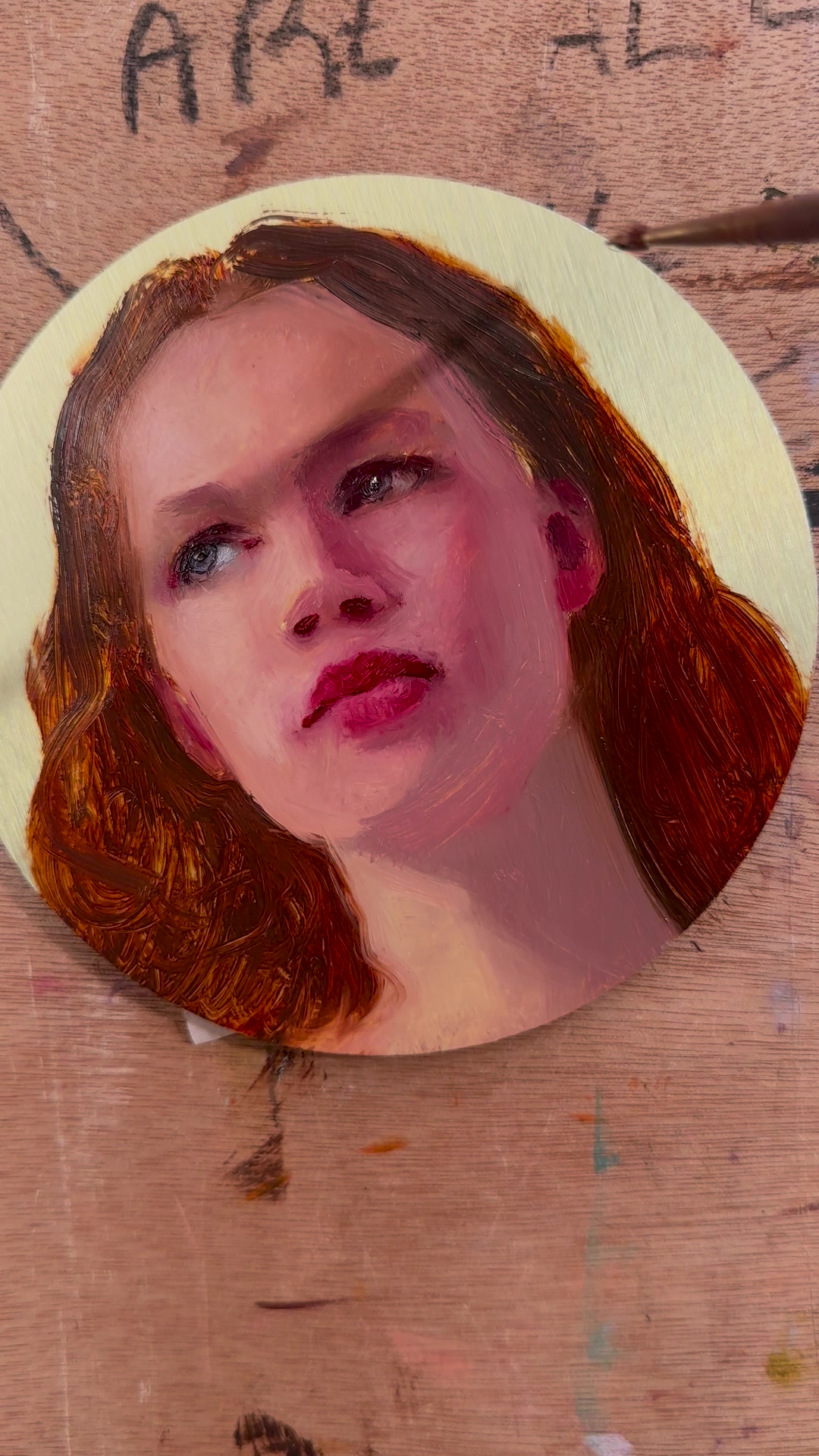 Refining the face of the portrait on the aluminium panel