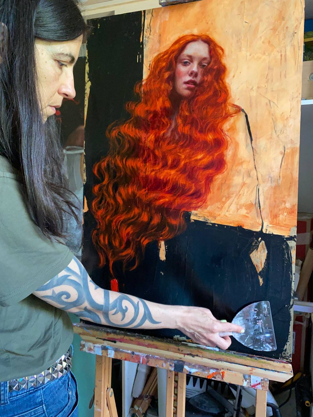 Rosso in the studio with her paintings
