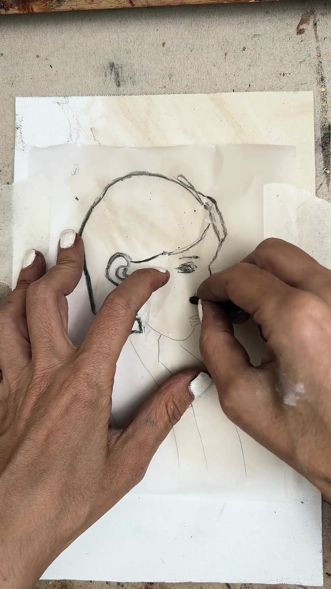 Tracing the lines of the drawing onto tracing paper