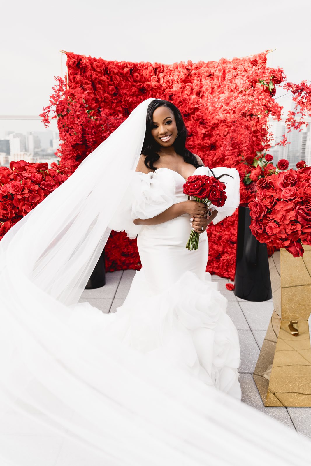 Bride in a white gown with a red bouquet, from The Hustler Handbook