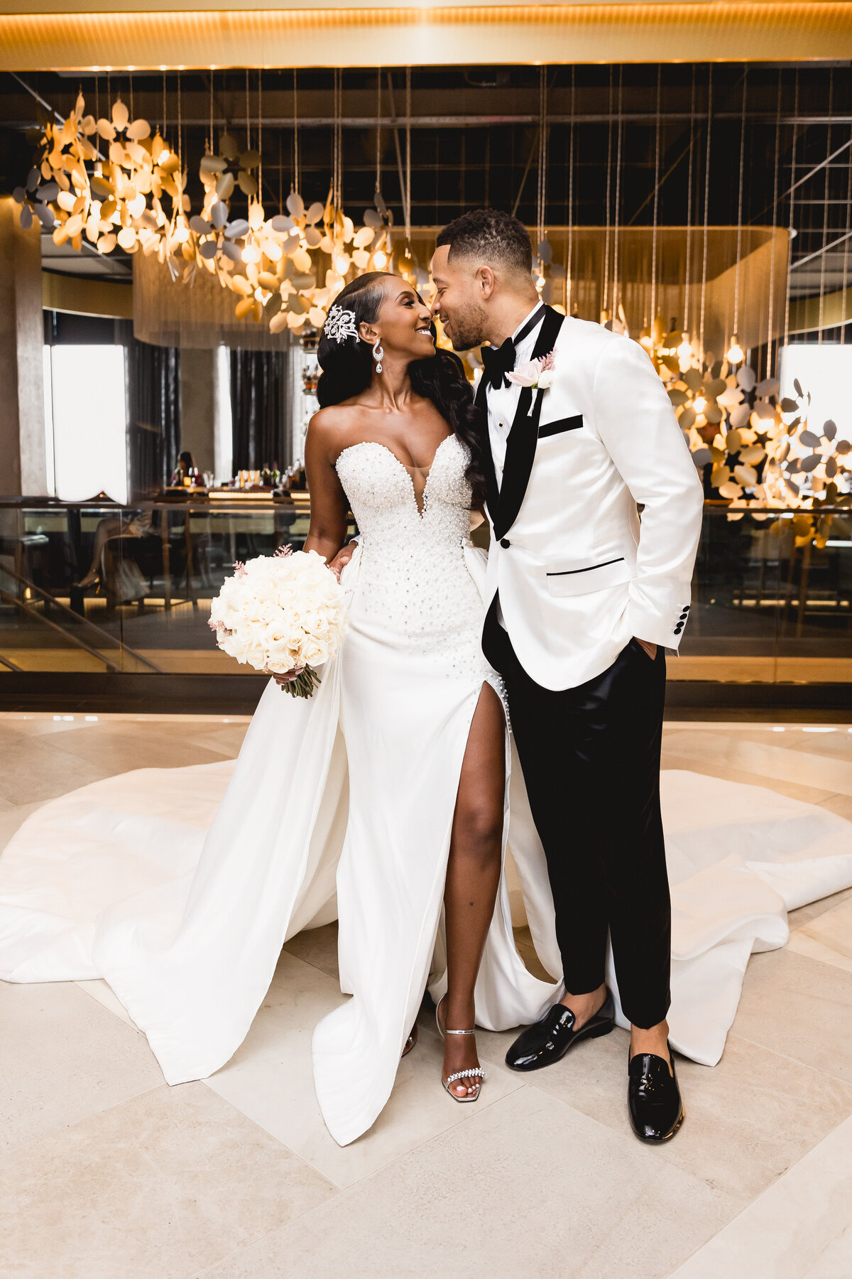 Couple posed under a chandelier