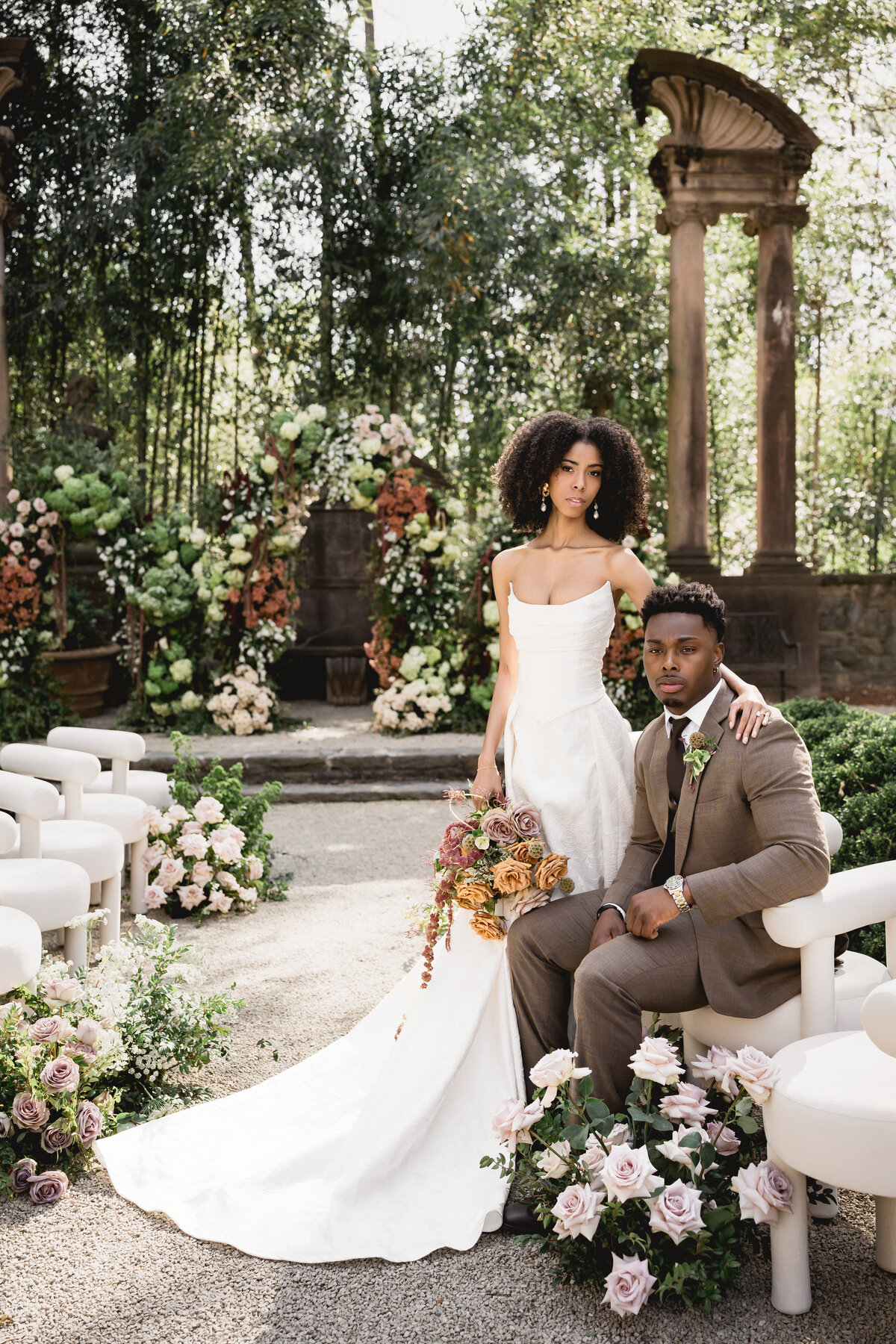 Couple posed in front of a floral installation