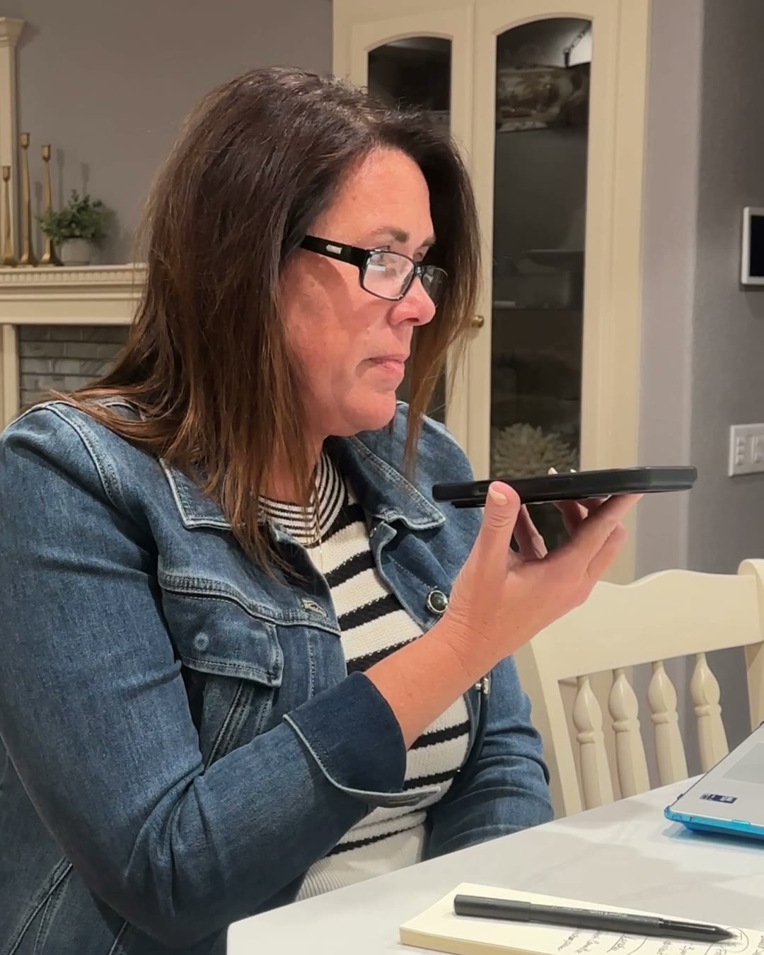 Brooke Baird at her kitchen counter, talking on speakerphone