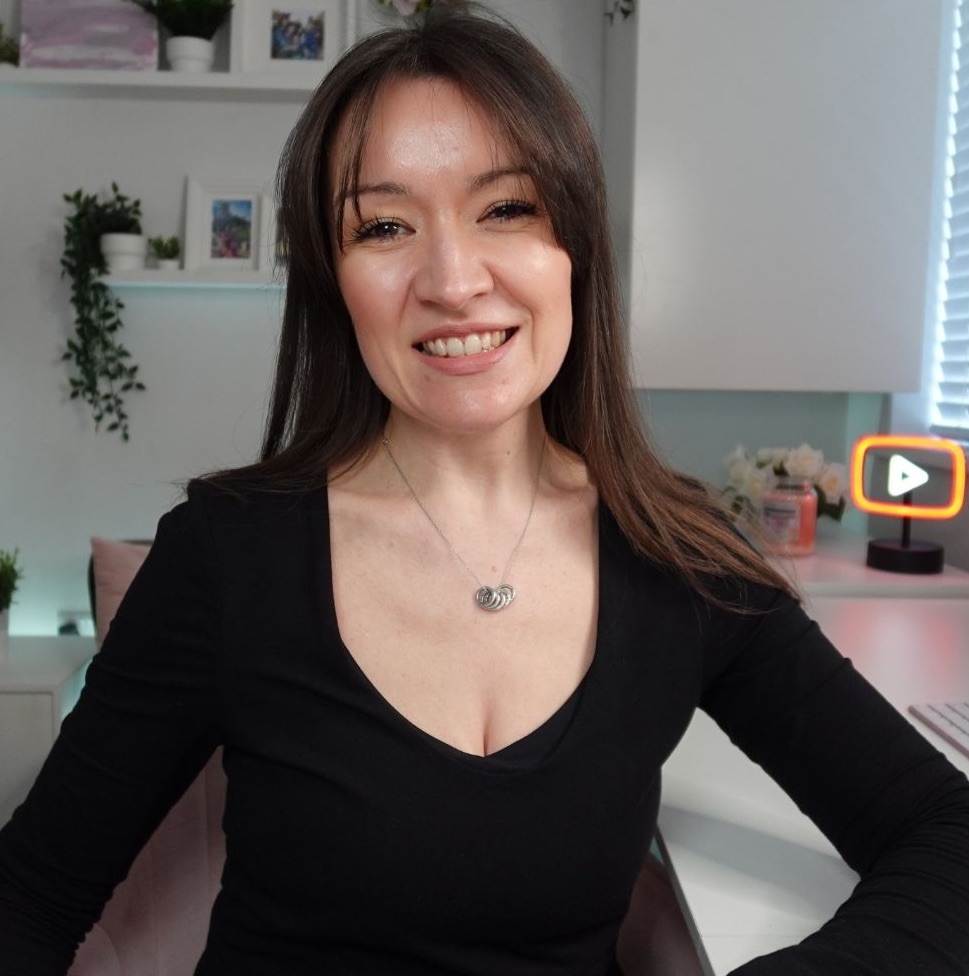 Rhi smiling at the camera in her office