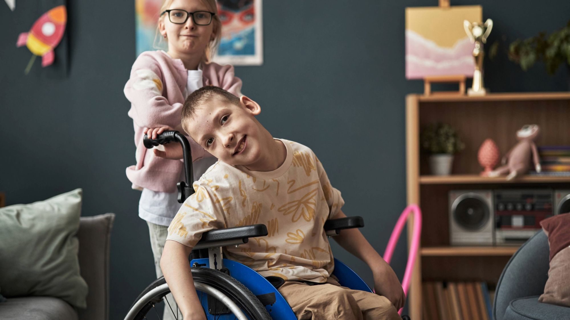 Young man in a wheelchair playing with his sister