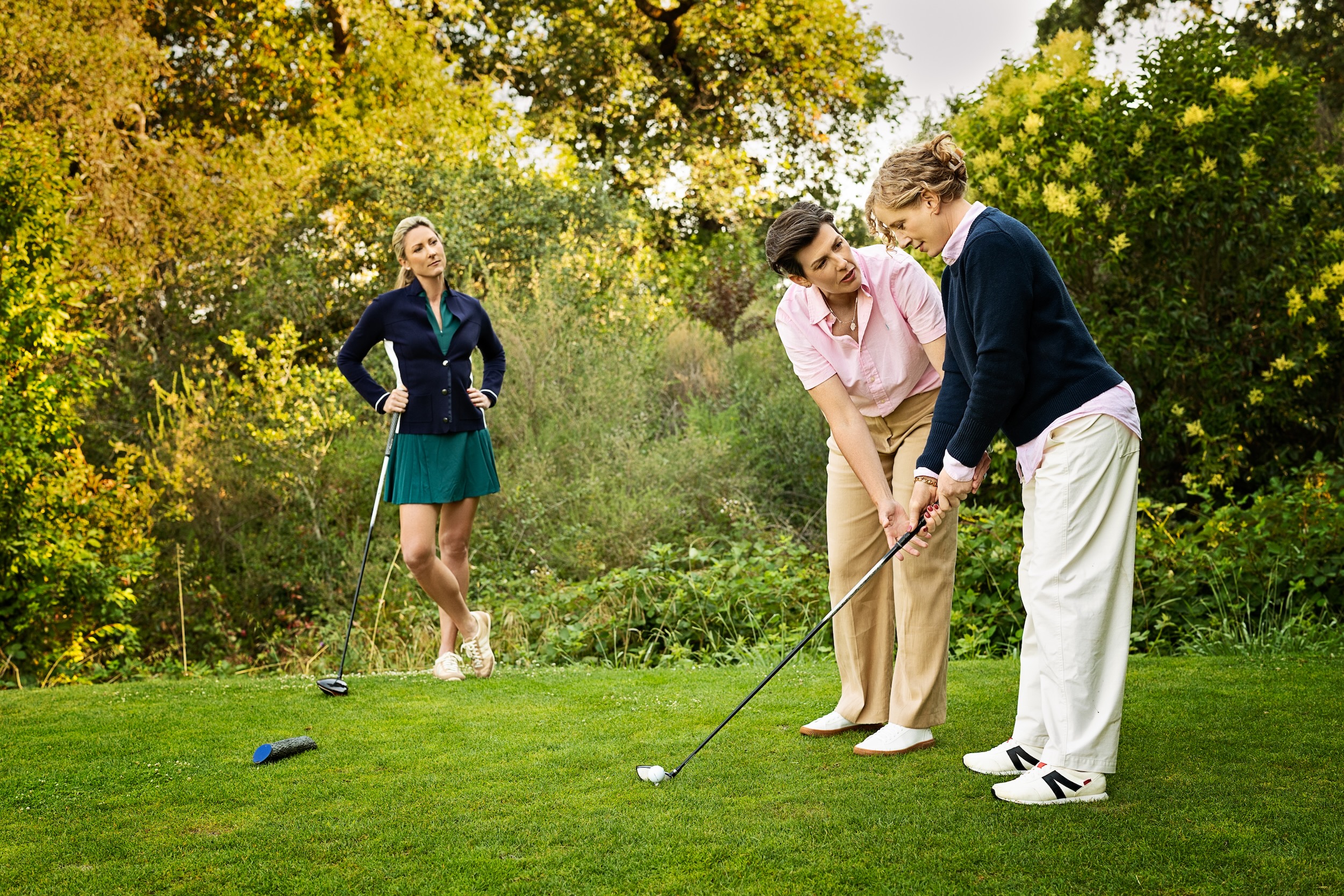 Amanda guiding a golfer on the putting green
