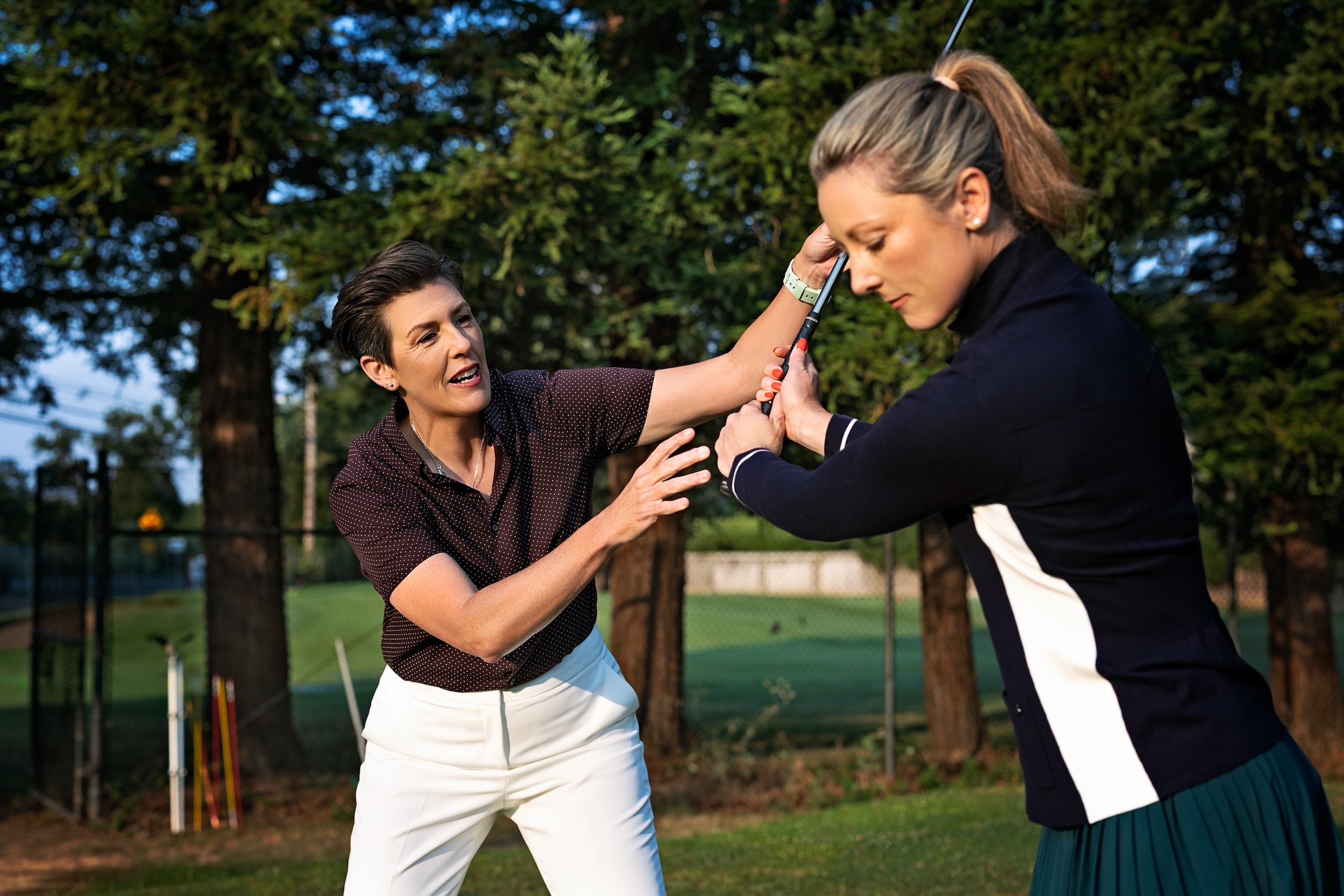 Amanda giving hands-on movement coaching to a golfer