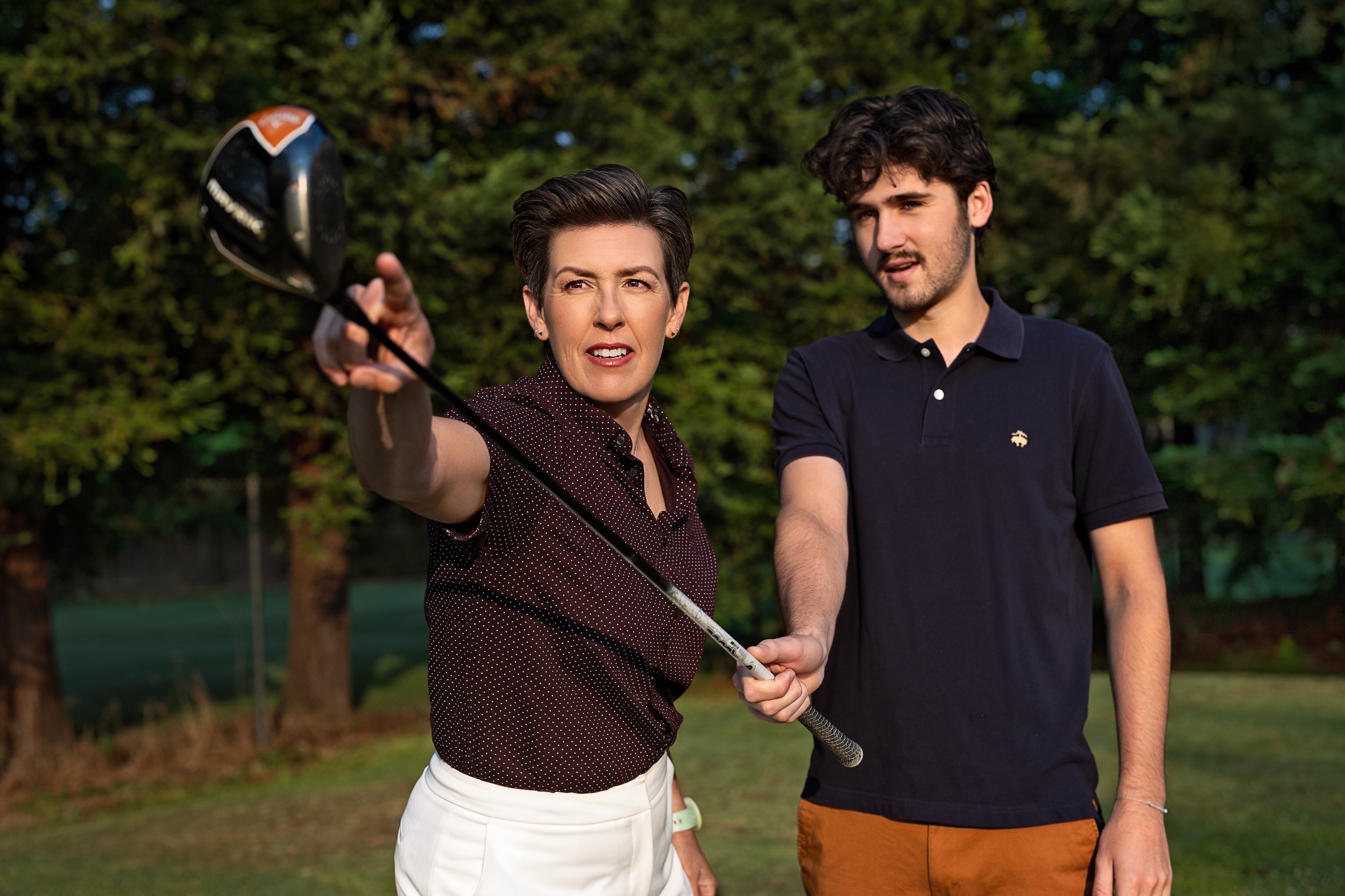 Amanda explaining driver setup to a golfer