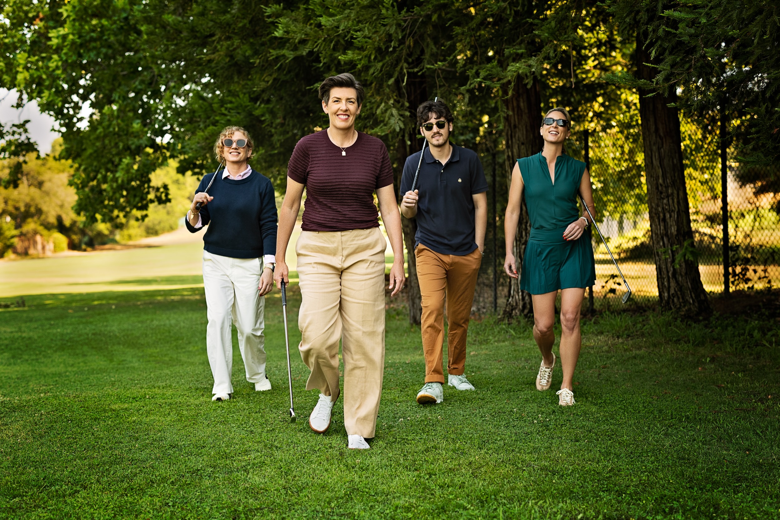 Amanda walking the golf course with a group of golfers