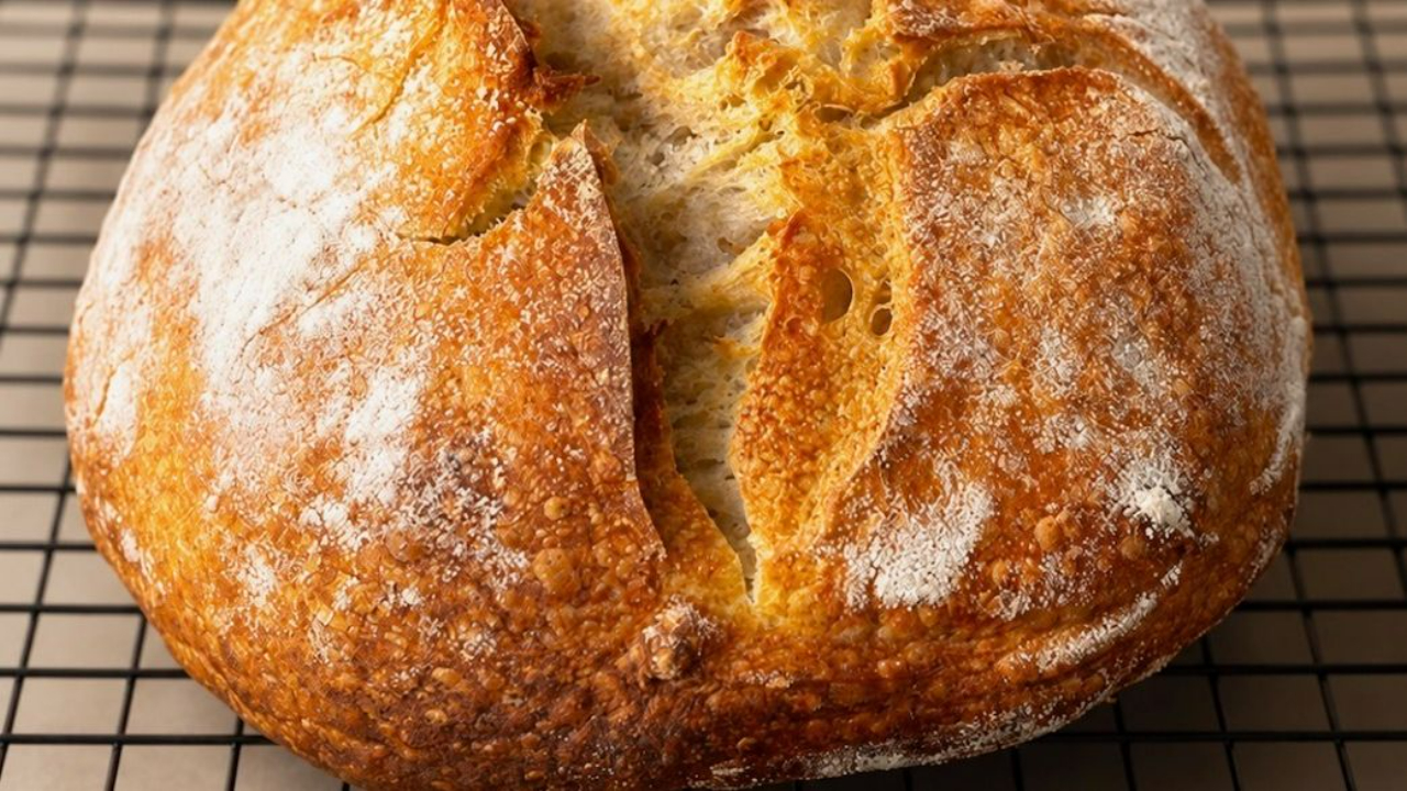 Golden artisan sourdough loaf with an open crumb