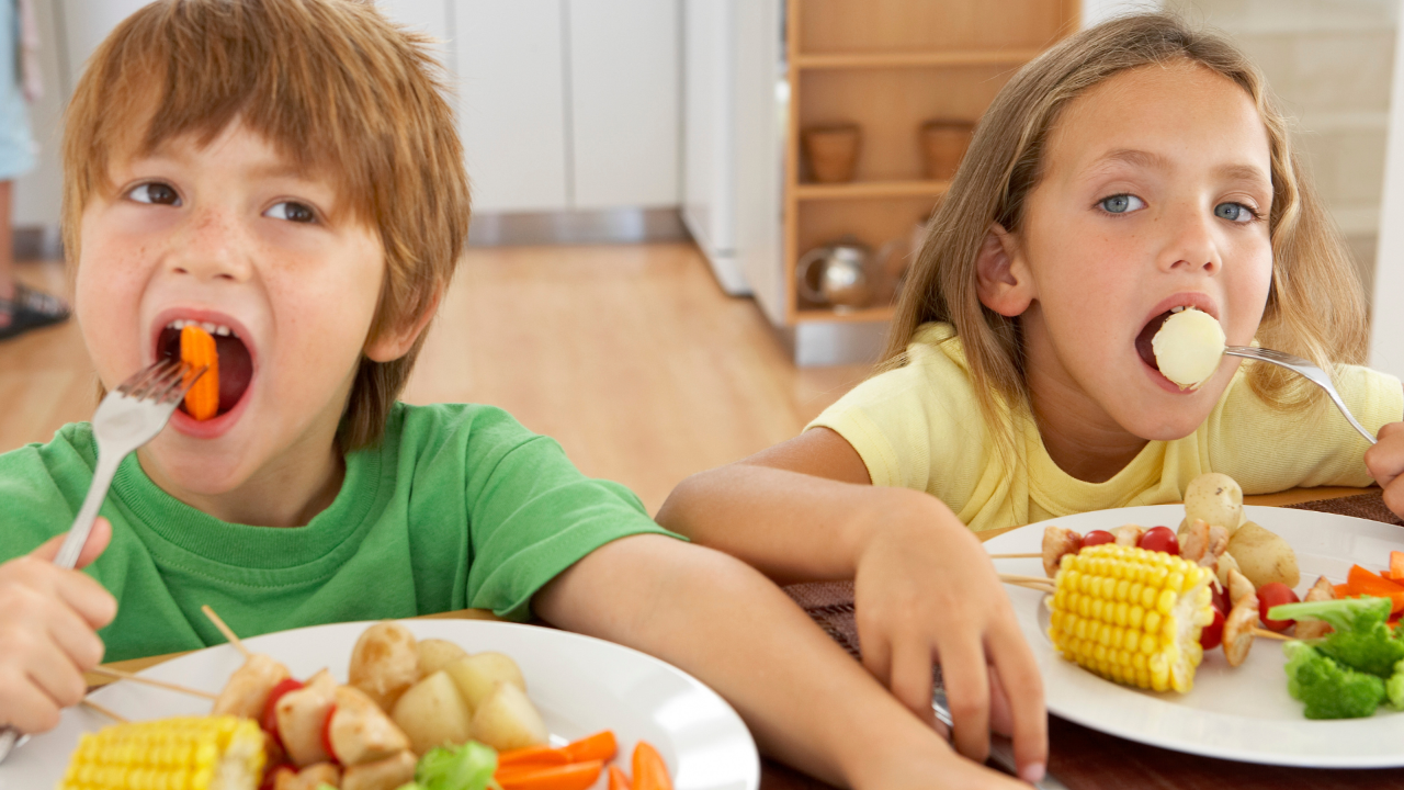Kids with healthy foods and stacked stones representing balance and gut health