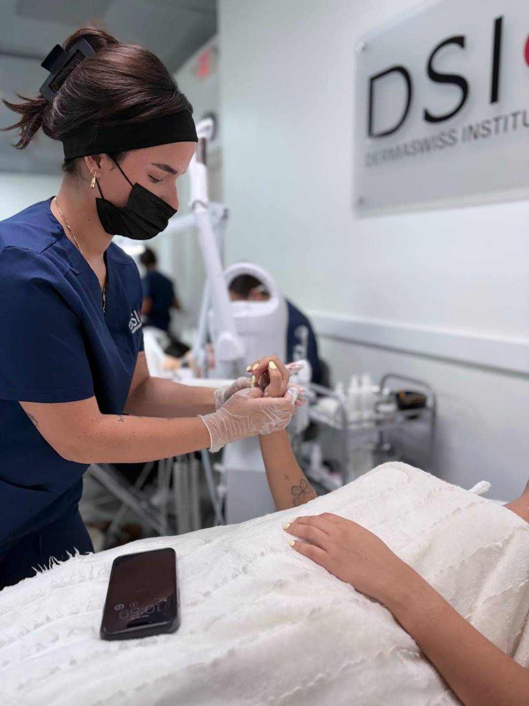 DermaSwiss Institute student performing a facial extraction procedure in the clinic