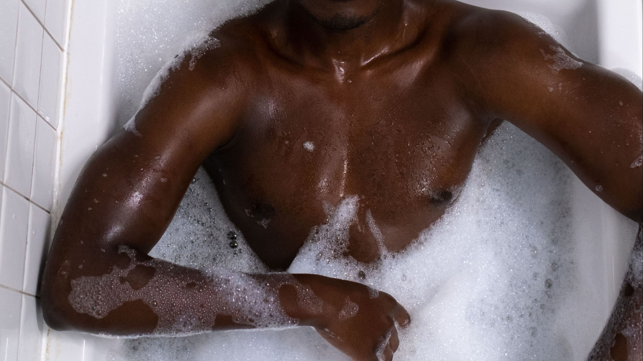 Man enjoying a relaxing and hygienic bubble bath in a bathtub.