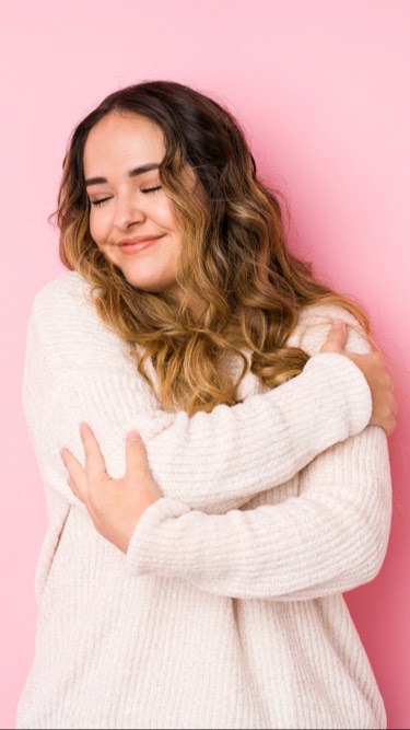 A woman hugging herself