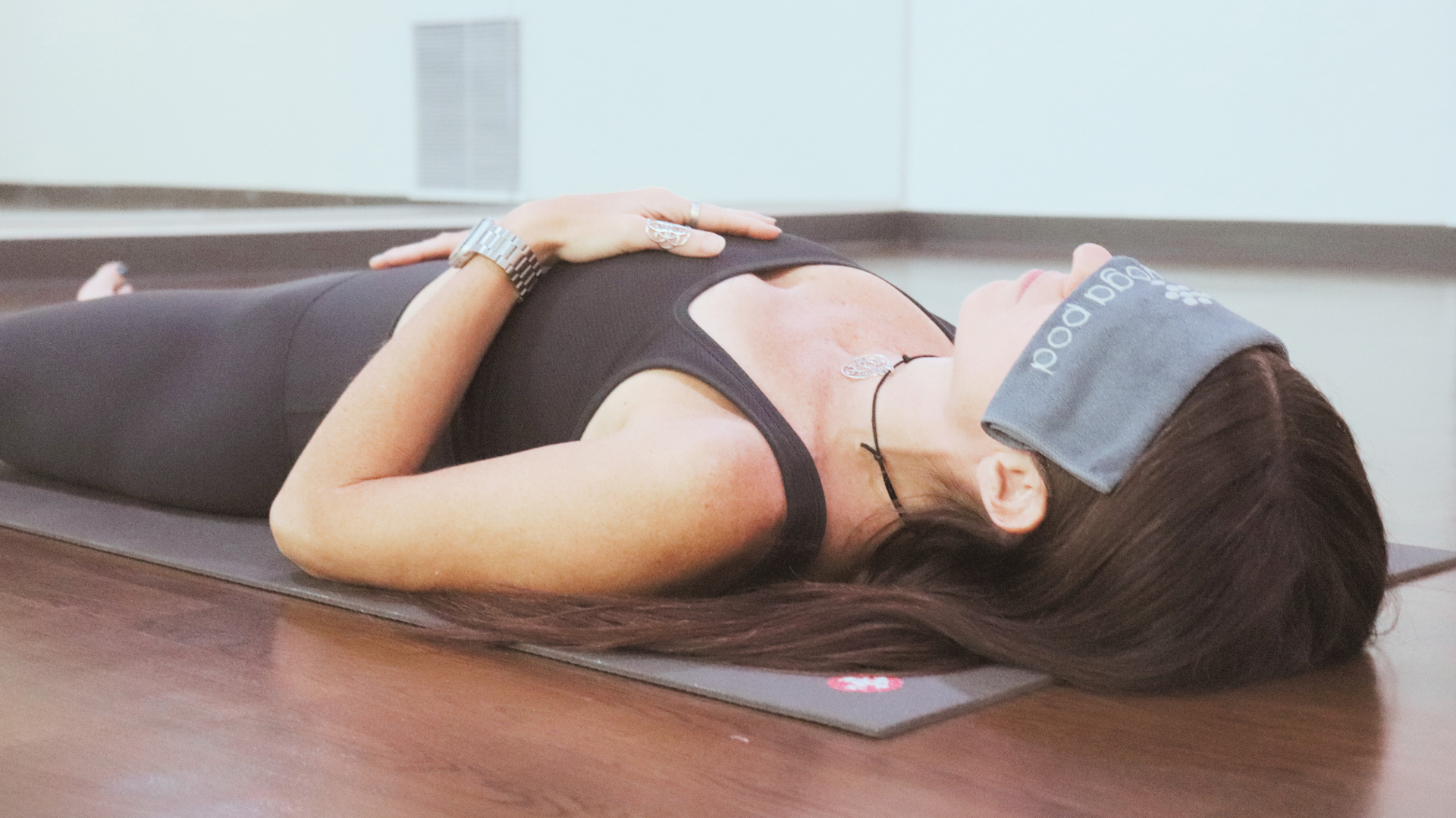 Student resting in a restorative mindful movement practice focused on relaxation and nervous system support