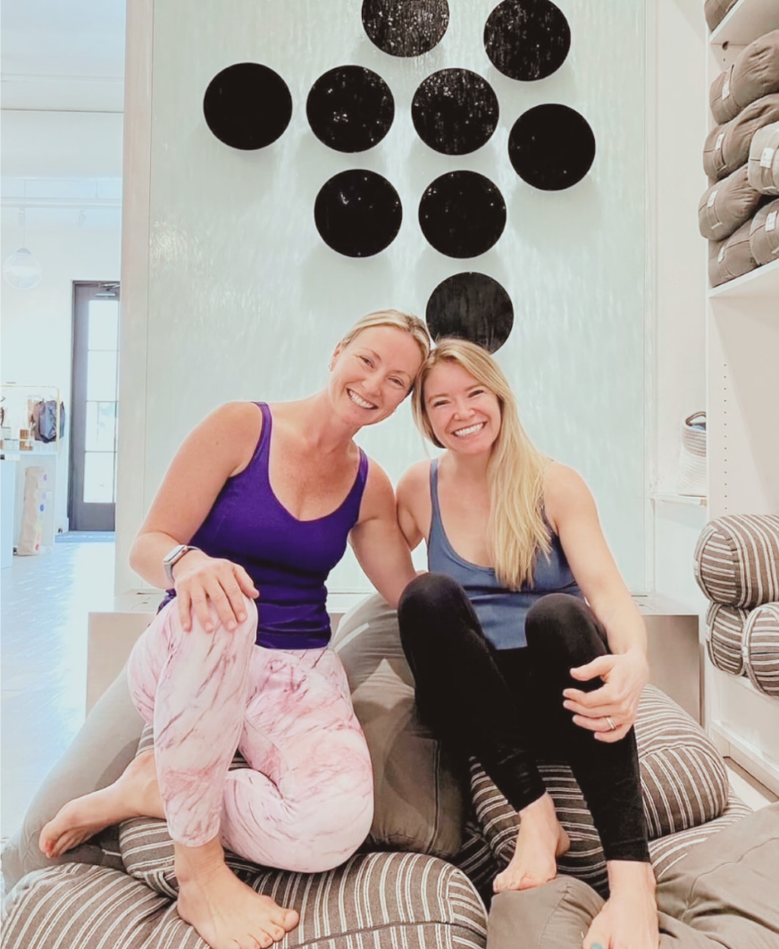 Founders of Mindful Movement Academy smiling together in a welcoming studio space