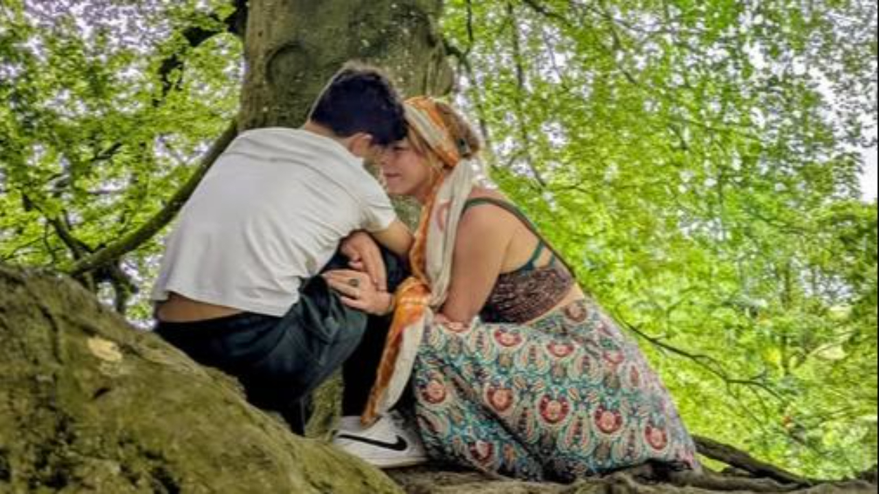 Mother hugging teen boy at Sacred Avebury Trees