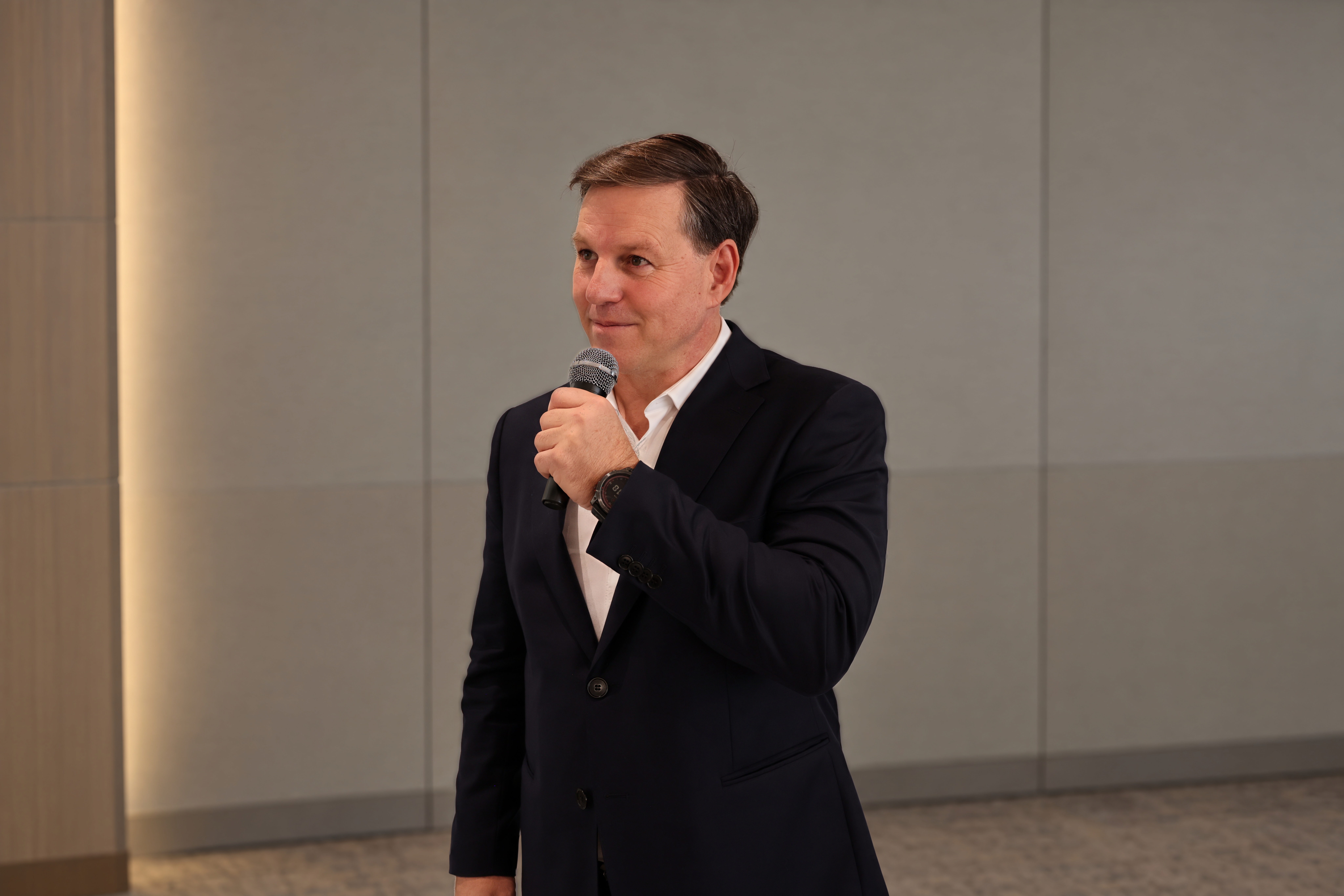 Gerard Barwell delivering a high-energy keynote presentation to a corporate audience