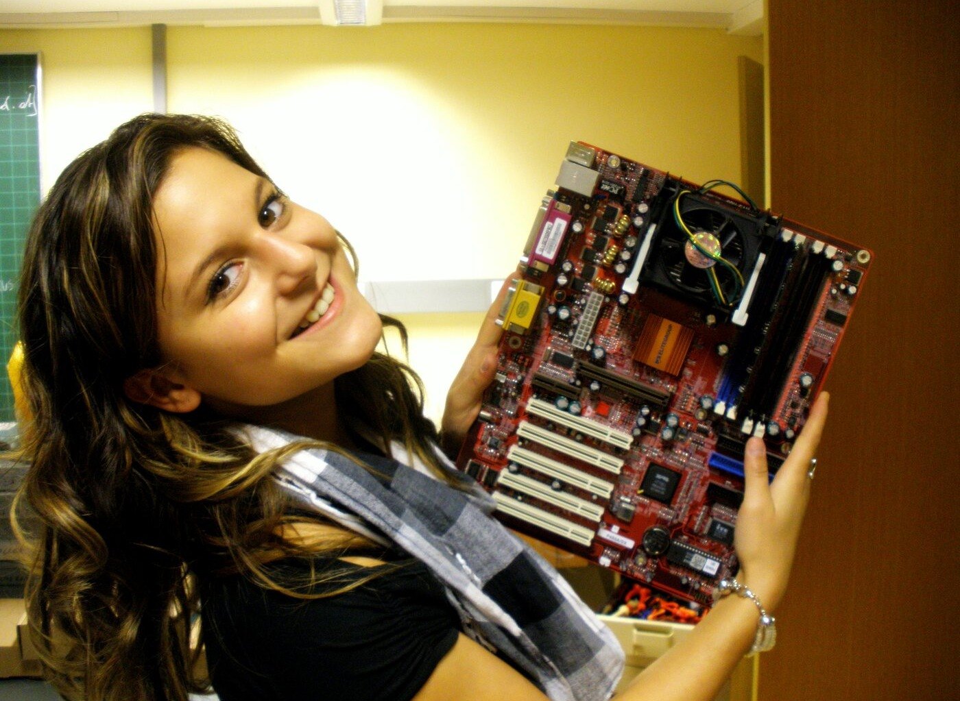 A young Linda holding a mainboard