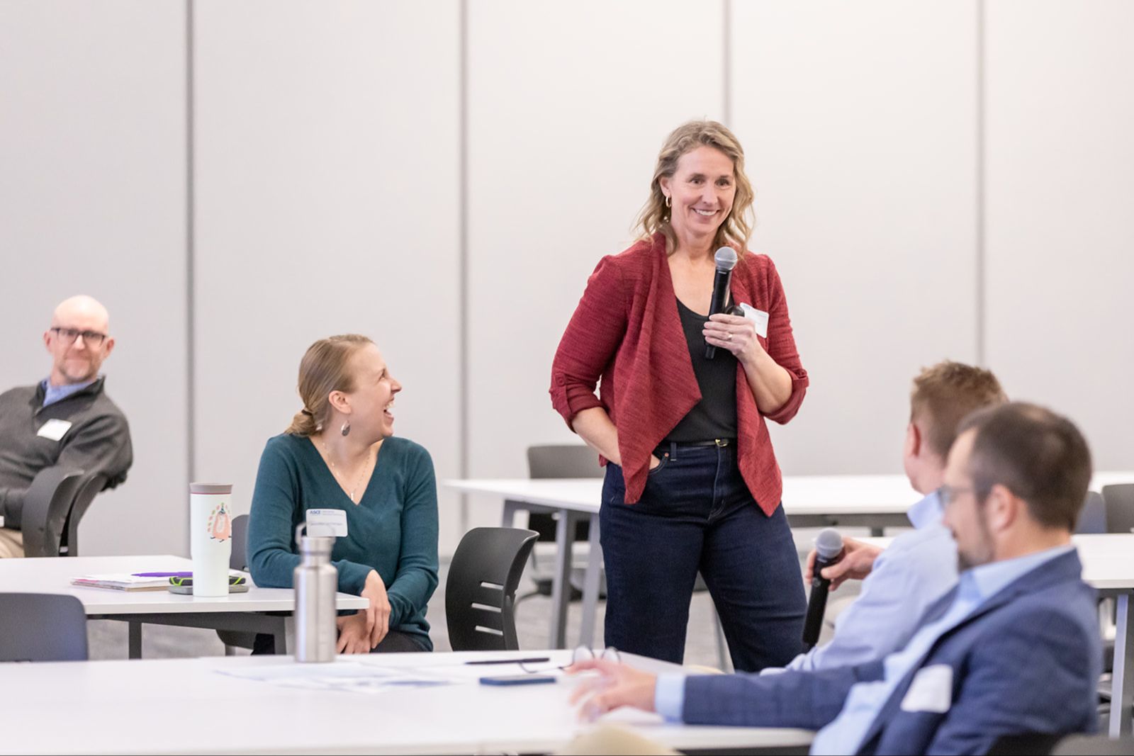 Allison Garner speaking on stage at a leadership event