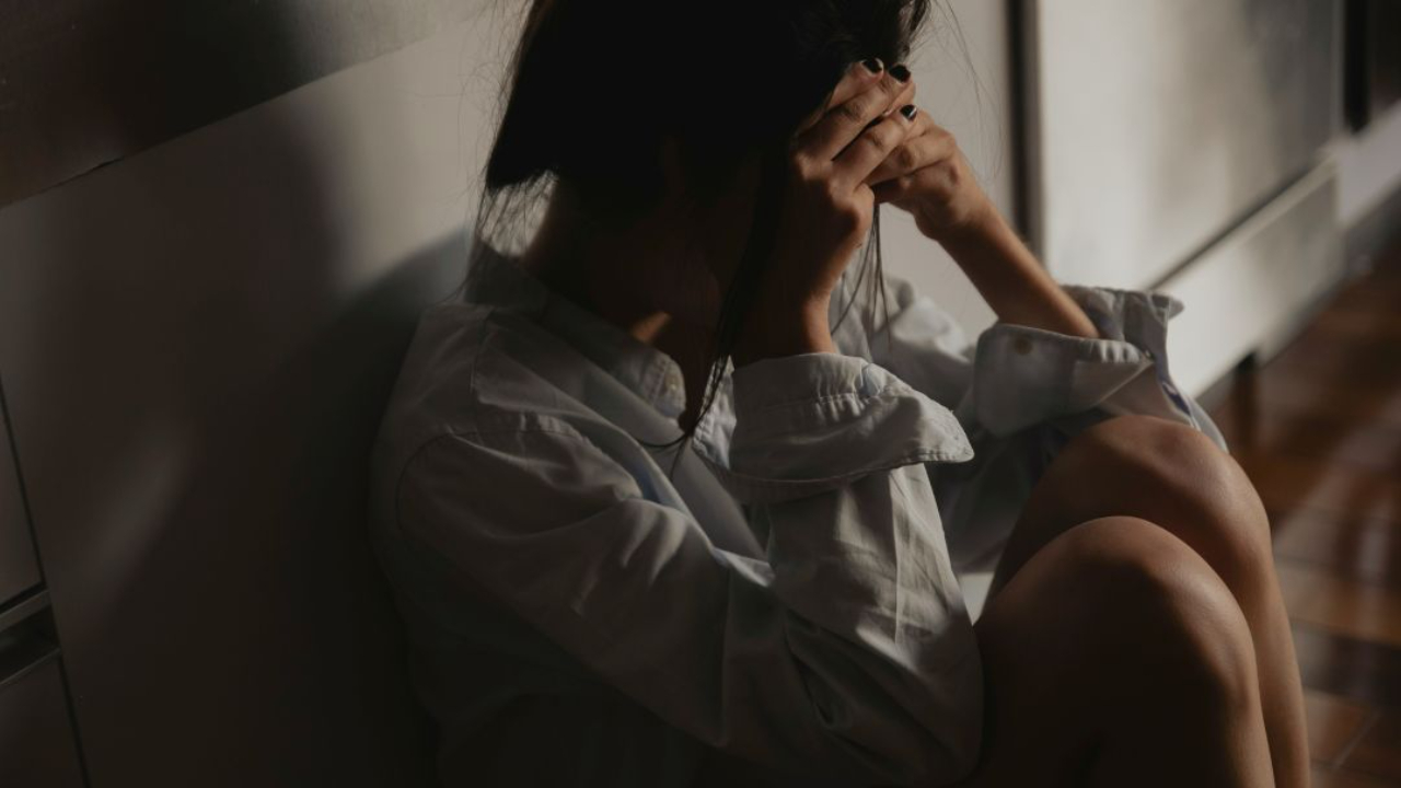 person depressed sitting on floor
