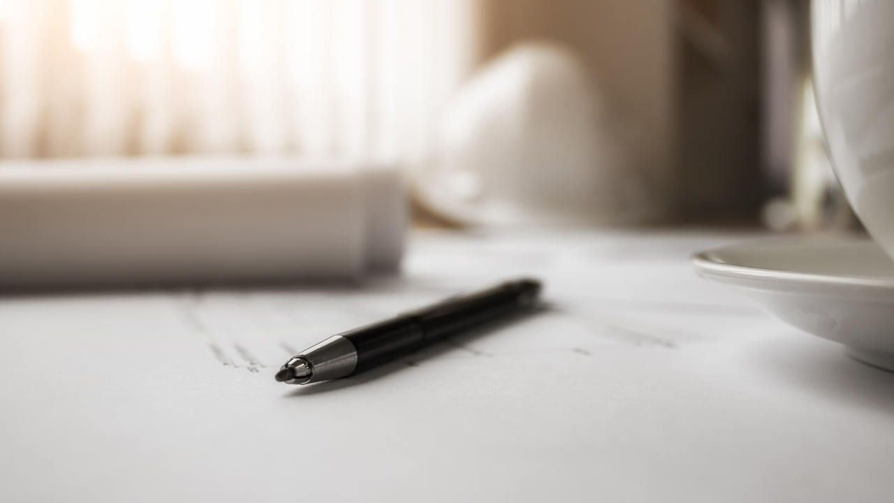 An extreme macro photograph of a fountain pen tip on paper, showing the high-resolution texture of the paper fibers and ink, representing deep self-observation.