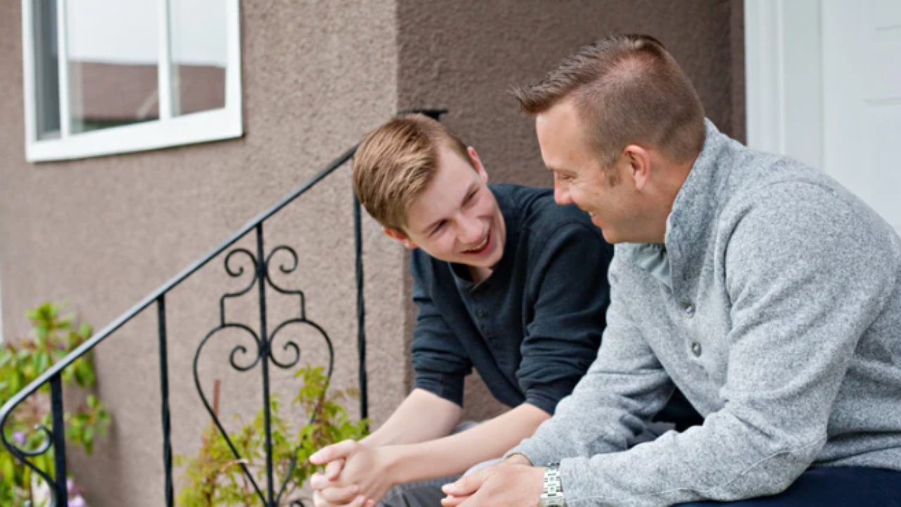 A parent sitting calmly beside their teenager, representing the shift from parental anxiety to present, grounded connection in pressure culture coaching