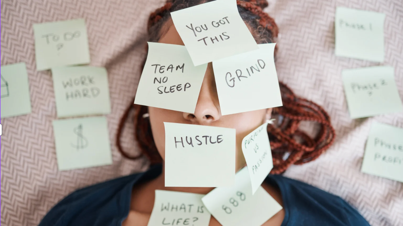 Teen with sticky notes covering face and torso with messages like “no sleep” and “grind,” representing pressure and overwhelm