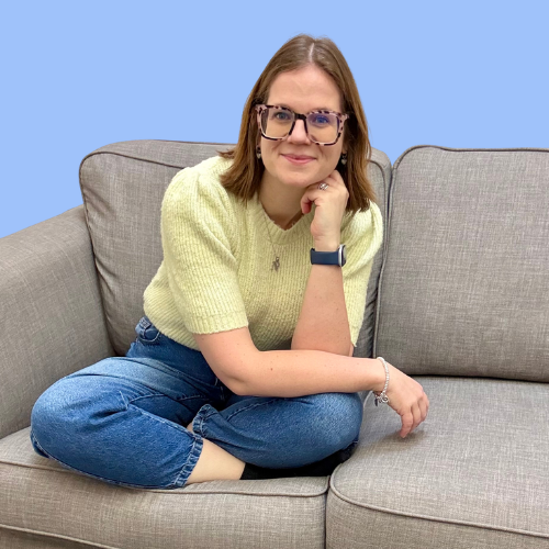 Dr Nicola Sutton seated on sofa smiling at camera