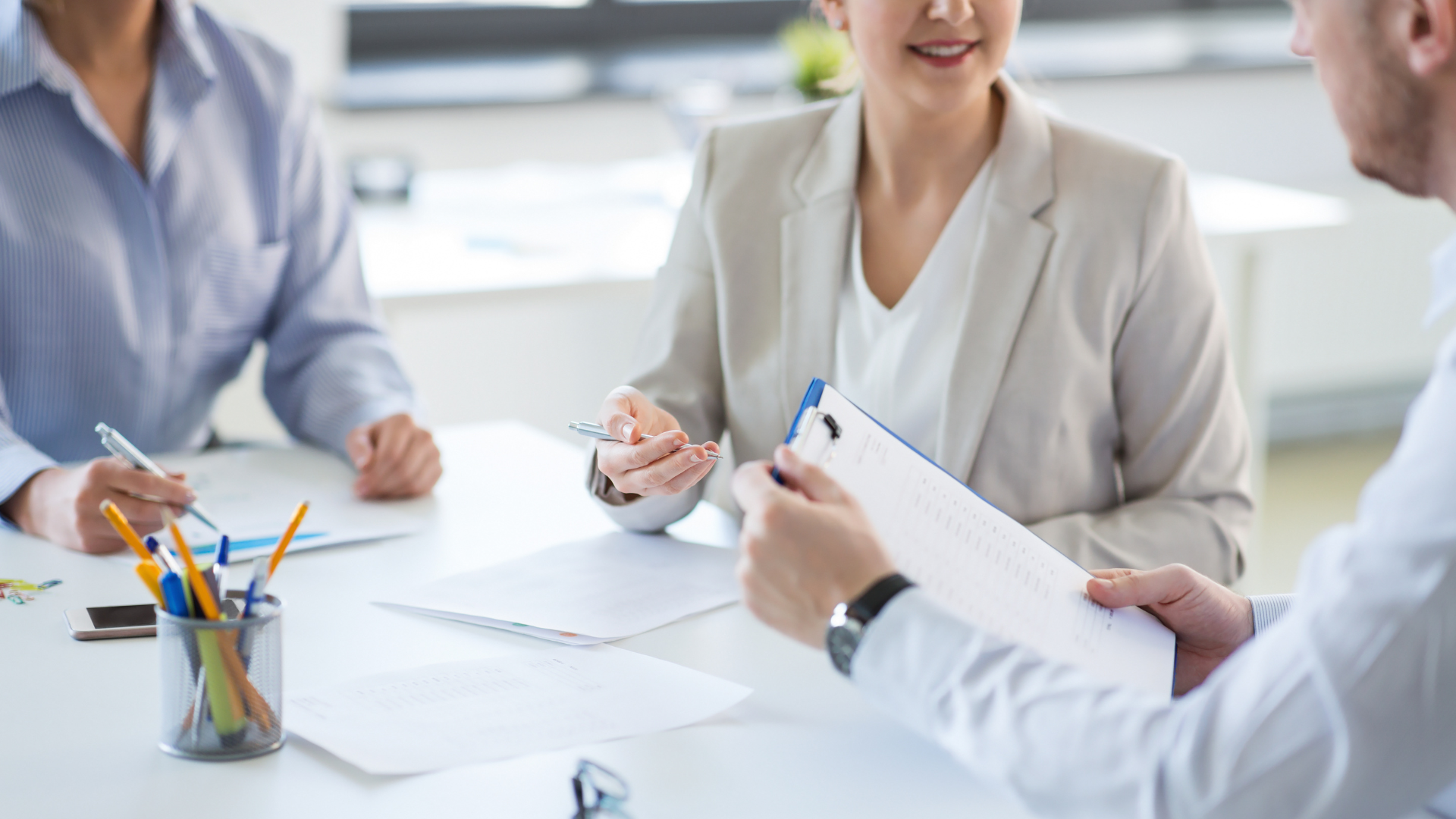 Professional woman shaking hands with a colleague and smiling